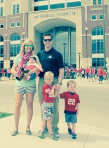 family in front of stadium